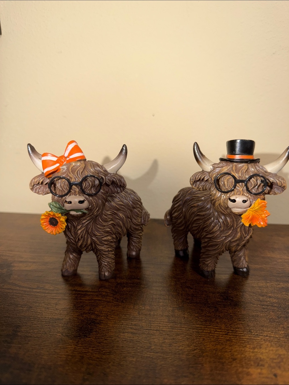 Festive Brown Highland Cow Figurine Pair with Orange Accents